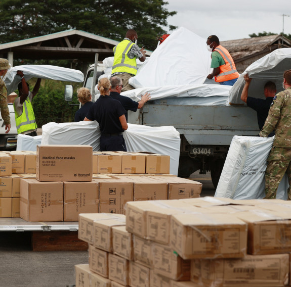 Medical supplies and soccer equipment are unloaded from a Hercules aircraft to deliver to Solomon Islands’ remote villages.