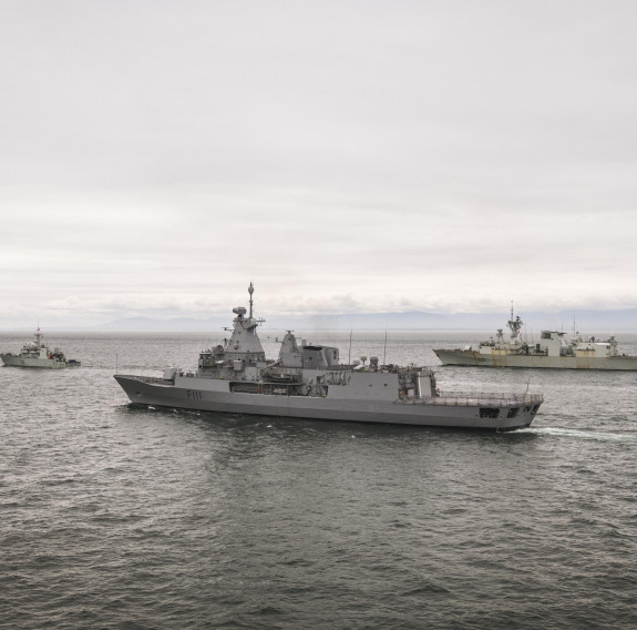 HMNZS Te Mana departing Esquimalt Harbour in Canada escorted by two Royal Canadian Navy ships.