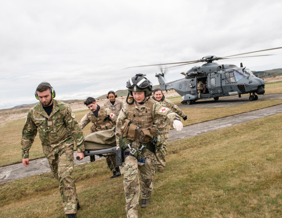 Aeromedical training - personnel carry a stretcher from the Royal New Zealand Air Force NH90 helicopter