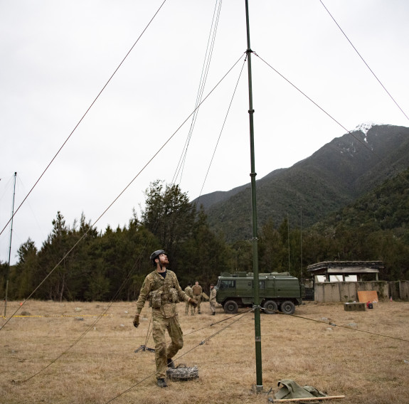 Personnel inspect the antenna that has been deployed in the field during Ex Cold Sparks.