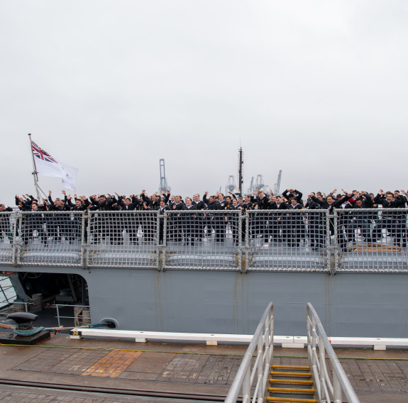 The Ship's Company of HMNZS Te Mana perform the Royal New Zealand Navy haka as they arrive at Devonport Naval Base