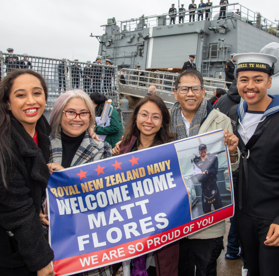 Family members celebrate the arrival of HMNZS Te Mana at Devonport Naval Base