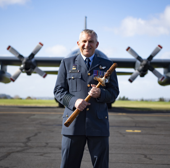 New RNZAF Base Auckland Commander Group Captain Mike Cannon with the base’s taiaha symbol of command