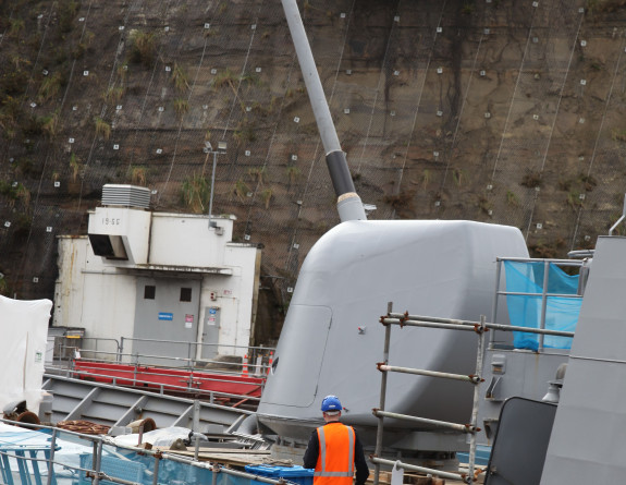Te Kaha's main gun undergoes maintenance checks while in the dry dock at Devonport Naval Base.