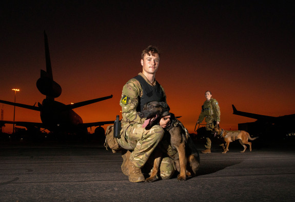 Royal New Zealand Air Force Military Working Dog Handler, Leading Aircraftman Byron Buys with dog Kaiser (forward) and Royal Australian Air Force, Military Working Dog Handler Leading Aircraftwoman Brooke Hitchinson with dog Karma