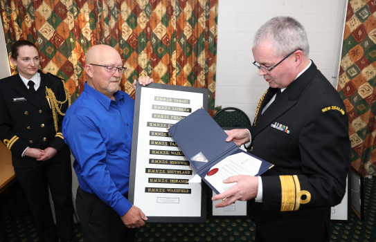 The Chief of Navy presenting Master At Arms (rtd) Shane Stokes with his tally board.