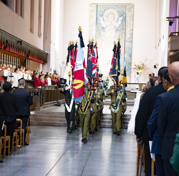 The Queen’s Colours and Her Majesty’s Personal Flag for New Zealand are paraded out of the Cathedral at the conclusion of the service.