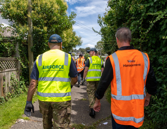 NZDF personnel wearing high vis are assisting Auckland civil defence and emergency authorities clean up from previous severe weather.