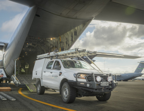 Connectics vehicles and electrical specialists are loaded on board a C-130 Hercules for transportation to Northland.
