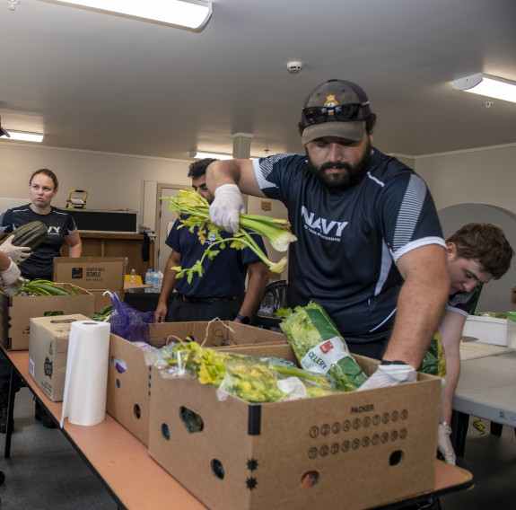 HMNZS Te Mana ship’s company assist with lunch preparations at the Rodney Green Centenial Centre, Napier CDC