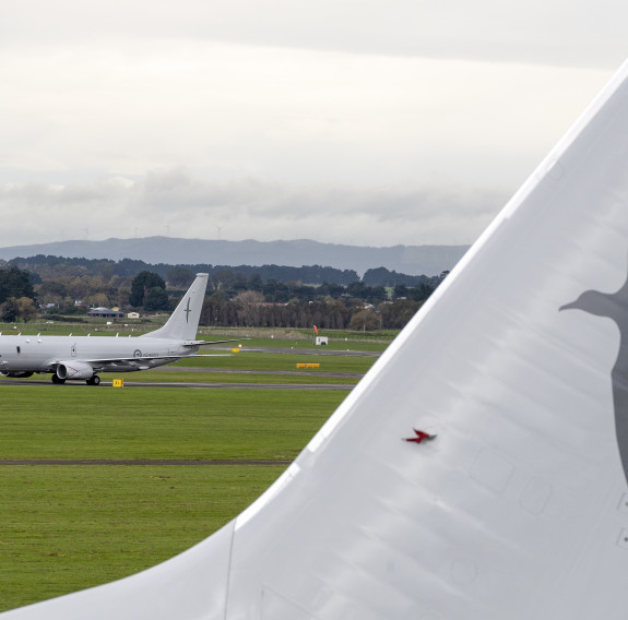 Behind the tail of another P8-A, which has an albatross painted on it in a darker grey, is the newest arrival to the fleet making it's way to the apron.