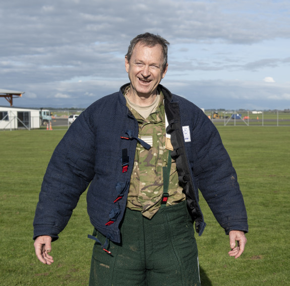 Group Captain Rob Shearer with the bite suit jacket undone and helmet removed smiles at the camera after experiencing the MWD capability first-hand at Base Ohakea.