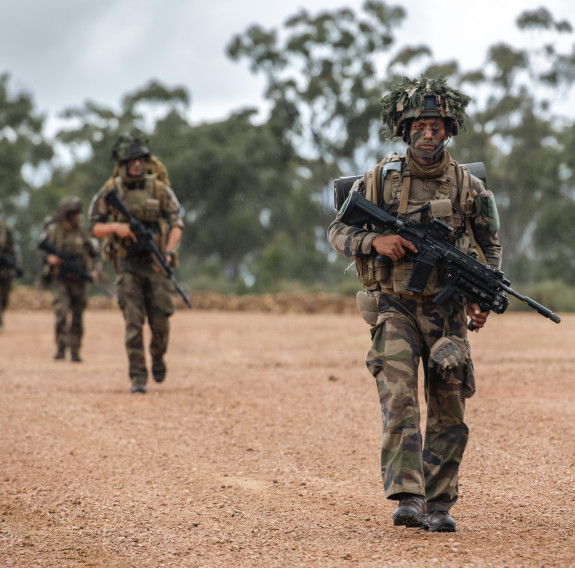 French soldiers working with NZ Army and Royal NZ Air Force personnel clear a helicopter landing zone during Exercise Talisman Sabre.