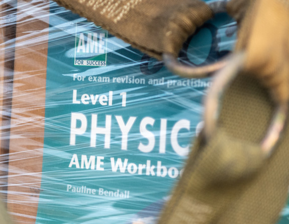 AME Level 1 Physics workbooks are boxed, wrapped and secured on a pallet for transit.