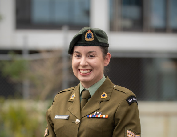 A woman in NZ Army uniform smiles at the camera.