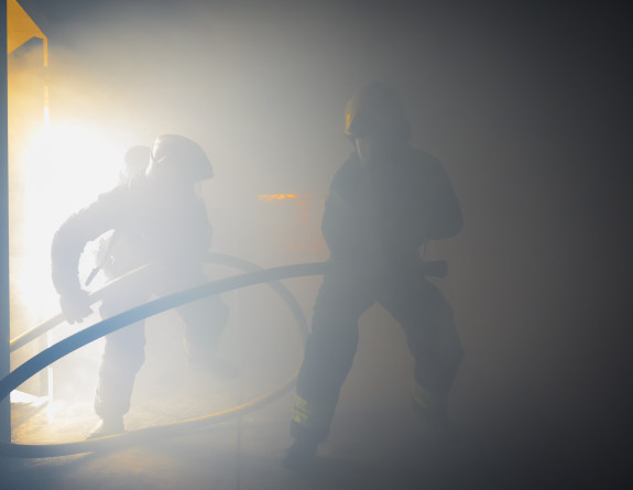 Two personnel in firefighting uniform - cloudy looking.