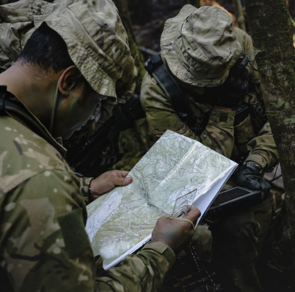 Soldiers check a map.