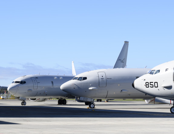 Three Poseidon on the tarmac outside of the hangar.