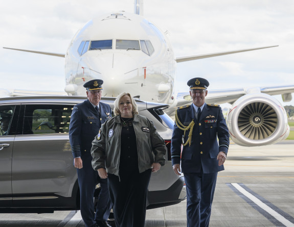 The Minister of Defence walks away from a car as she arrives to the event in front of a Poseidon aircraft.