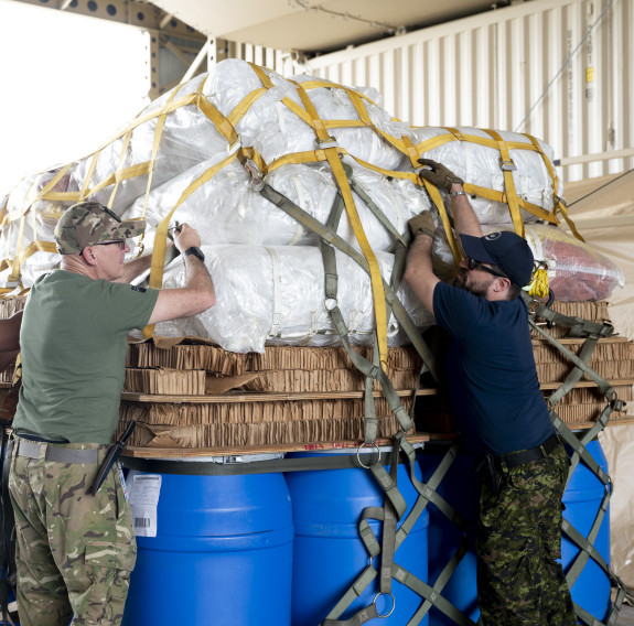 Members of the Royal New Zealand Air Force and Royal Canadian Air Force work together to unpack cargo during Mobility Guardian 23 at Andersen Air Force Base, Guam. 