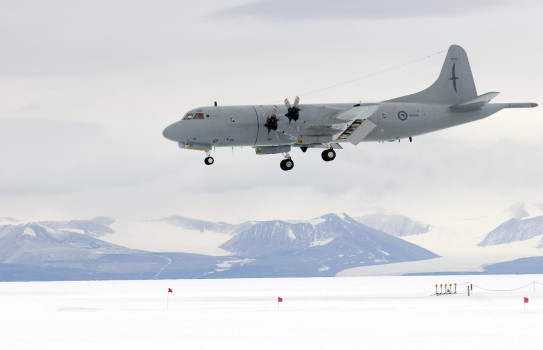 P-3K2 Orion coming in to land on the Pegasus runway in overcast conditions with mountains protruding from the snow.