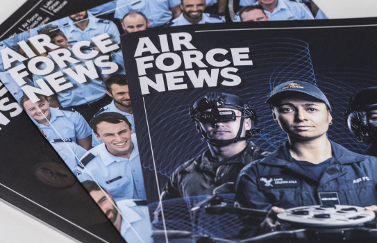 Three editions of Air Force News stacked a table