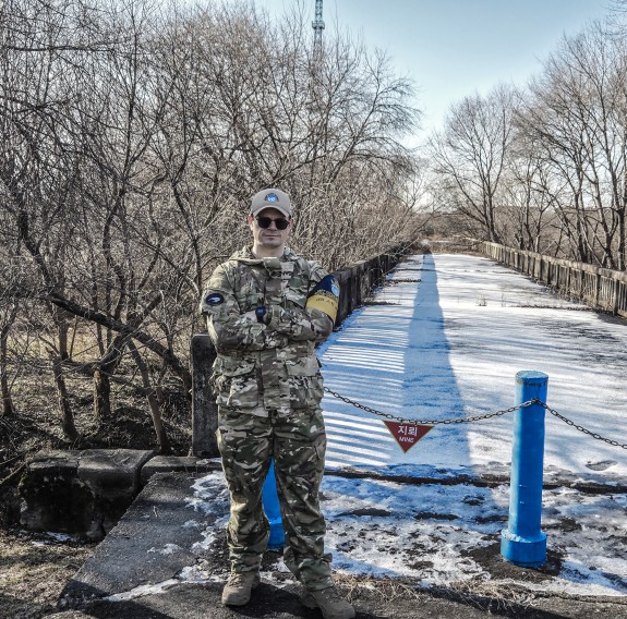 Peacekeeper standing in front of bridge