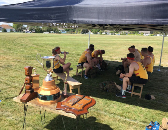 NZ Army reserve force take a break between games with the Eric Batchelor Cup in the foreground.