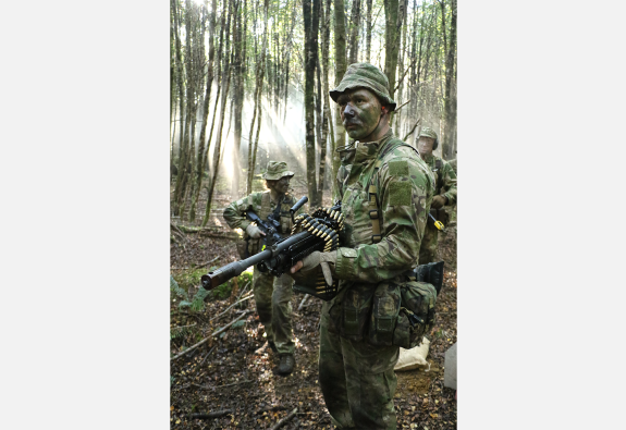 Soldiers patrolled through the bush with stealth