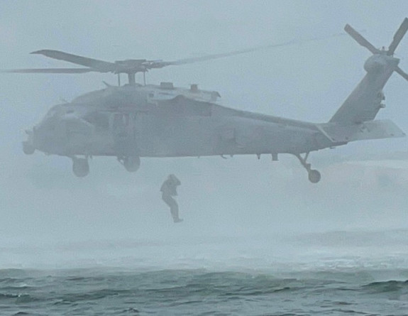 Able Diver William Collings from HMNZS Matataua is lowered into the sea from an MH60S Seahawk to deal with a mine