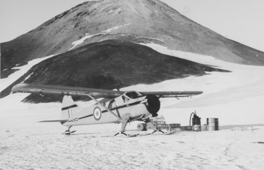 Antarctic Flight Beaver parked at Scott Base, Antarctica, ready to be refuelled. Observation Hill in the background.