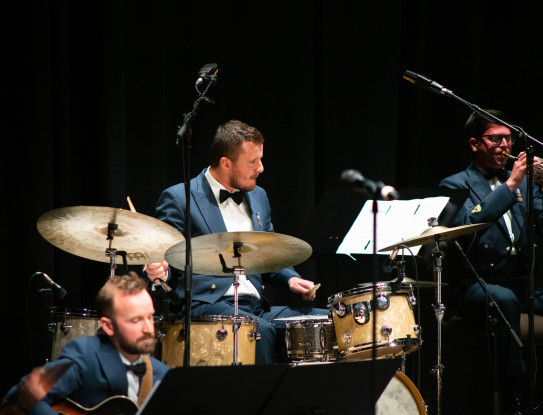 Corporal Jeremy Richardson playing the drums in the RNZAF Band