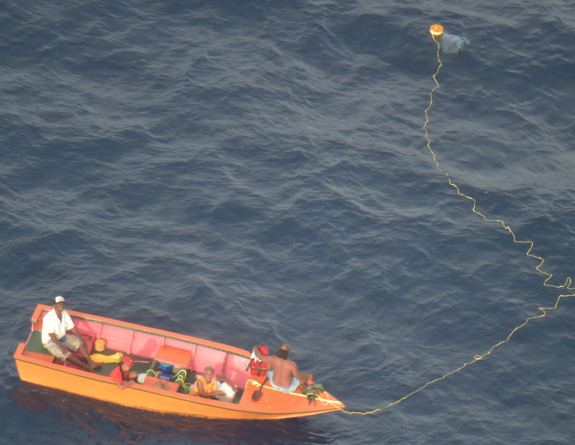 Four people on a missing boat from Kiribati, photo taken from an RNZAF Orion.