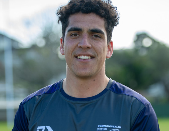 Royal New Zealand Navy Able Electronics Technician Conrad Kutia, of Te Taua Moana rugby team, will be competing in the Commonwealth Navy Rugby Cup tournament in the United Kingdom this month. Conrad holds a rugby ball and smiles towards the camera. 