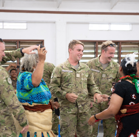 Lance Corporal Ollie Brind, centre, enjoying a community event at one of the halls they worked at.