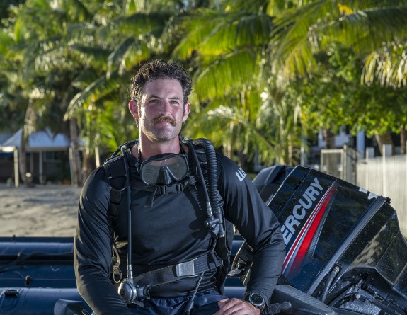 Lieutenant Christian Lloyd sits on a boat while its set on the beach