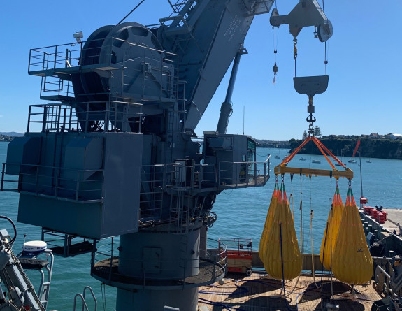 The main crane of HMNZS Manawanui conducts a load test before deploying the ROV.