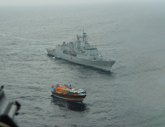 A view from HMNZS Te Kaha’s Seasprite, as Te Kaha closes with a vessel of interest loaded with vehicles and other cargo.