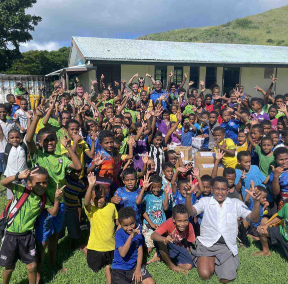 RNZAF No. 3 Squadron flight crew members pose for a group photo with children from Ratu Filimoni School. Photo credit: Ravuama Nagalevu of Western Commissioners Office.