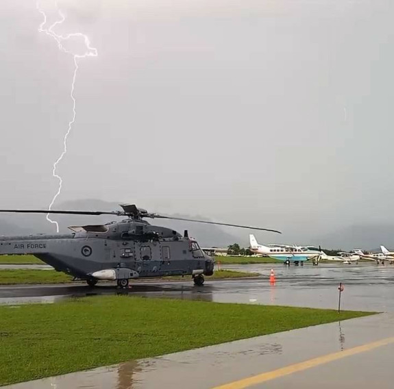 An RNZAF NH90 helicopter on the ground at Nadi aerodrome waiting for a thunderstorm to pass.