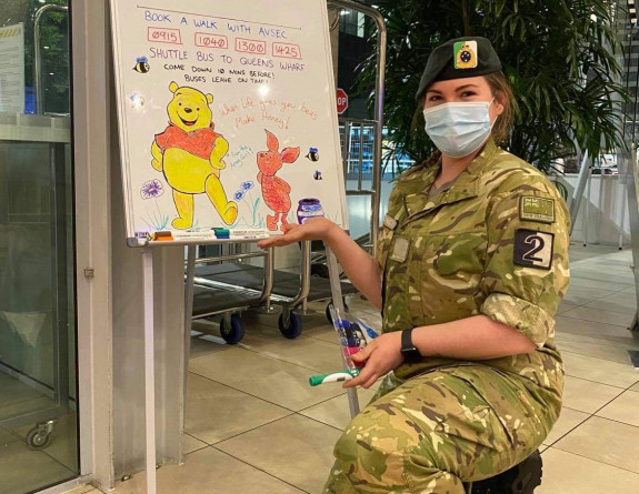 A New Zealand Army soldier in MIQ shows the daily board in the hotel. 