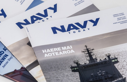 Three editions of Navy Today stacked a table
