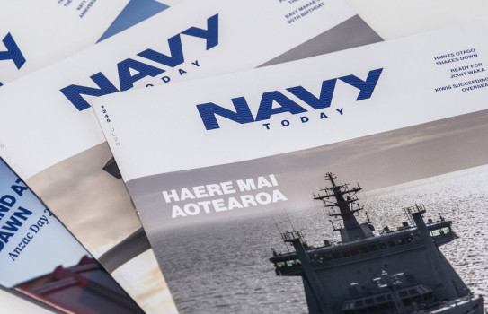 Three editions of Navy Today stacked a table