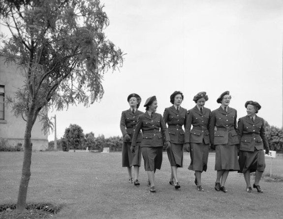 A black and white historical photo of six women walking through the grounds at Base Ohakea