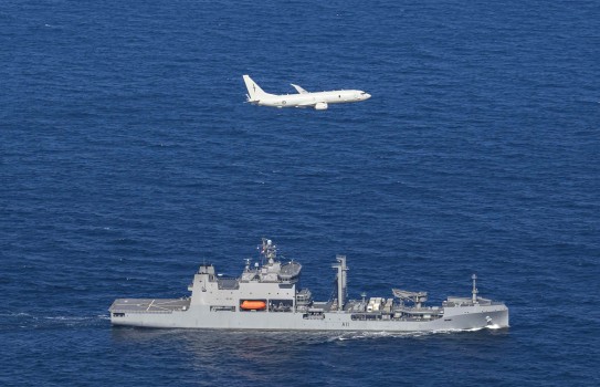 A Royal New Zealand Air Force P-8A Poseidon maritime patrol aircraft overflies HMNZS Aotearoa during surveillance and deterrence activities.