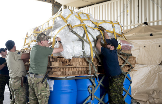 Members of the New Zealand Defence Force and Royal Canadian Air Force work together to unpack cargo during Mobility Guardian 23 at Andersen Air Force Base, Guam. U.S. Air Force photo by Staff Sgt. Malissa Lott.