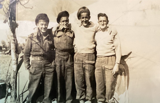 A sepia photo of four soldiers during the Second World War
