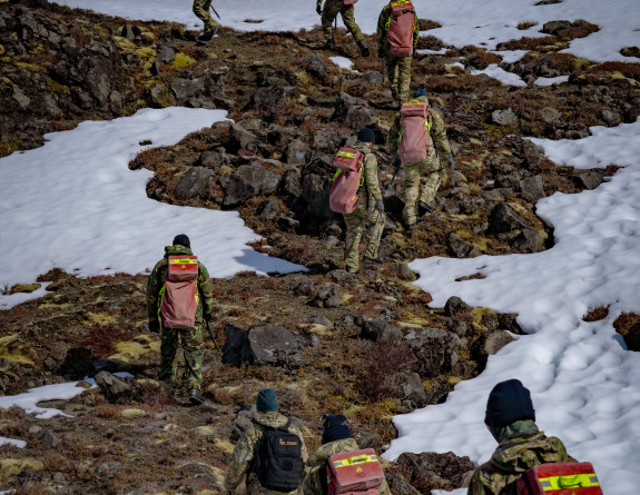 NZDF personnel walk up rocky mountain area as part of Personnel walk through the snow as part of five-day cold weather survival course on Mt Ruapehu