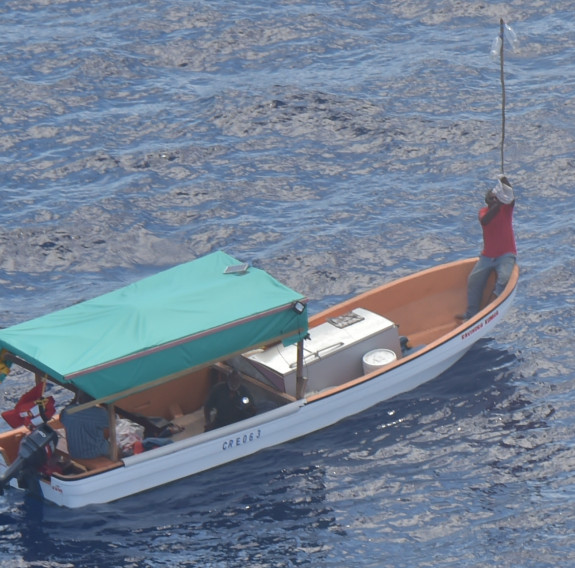 Three survivors on a small boat which was located well away from its original path to Suva, drifting in open water.