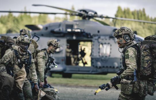 Soldiers prepare to board a Royal New Zealand Air Force NH90 helicopter to deploy to the Hokonui Hills area of operations